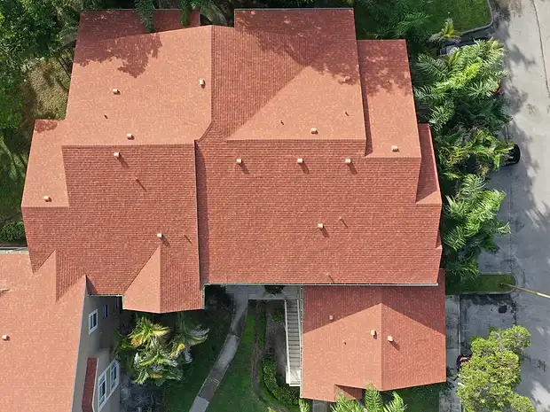 Top-down aerial of a home with a new terracotta shingle roof