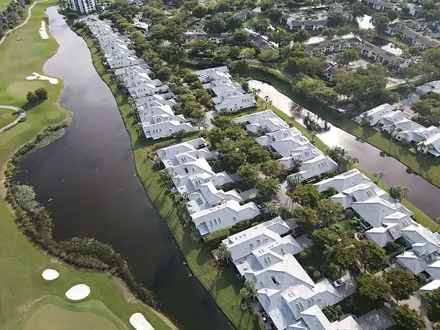 Aerial view of a lakefront community with new roofs