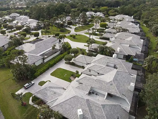 Aerial view of an estate community with grey tile roofs