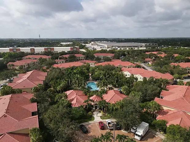 Aerial view of a Palm Beach County community with barrel tile roofs