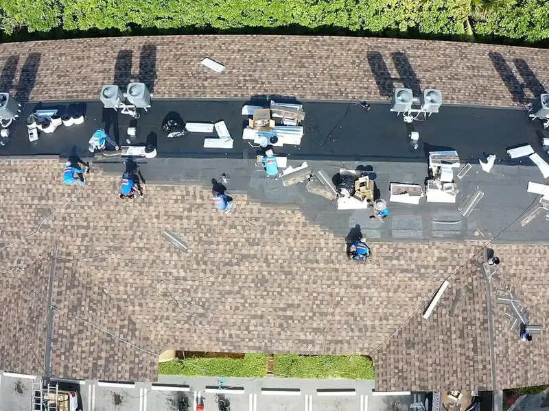 Molsbee crew working on a shingle roof, seen from above