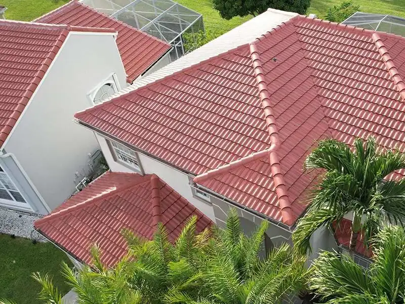 Red clay barrel tile roof on a screened pool home